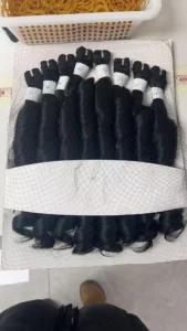 Wholesale Human Hair Wigs - bulk raw hair bundles laid on the floor for sorting and grading