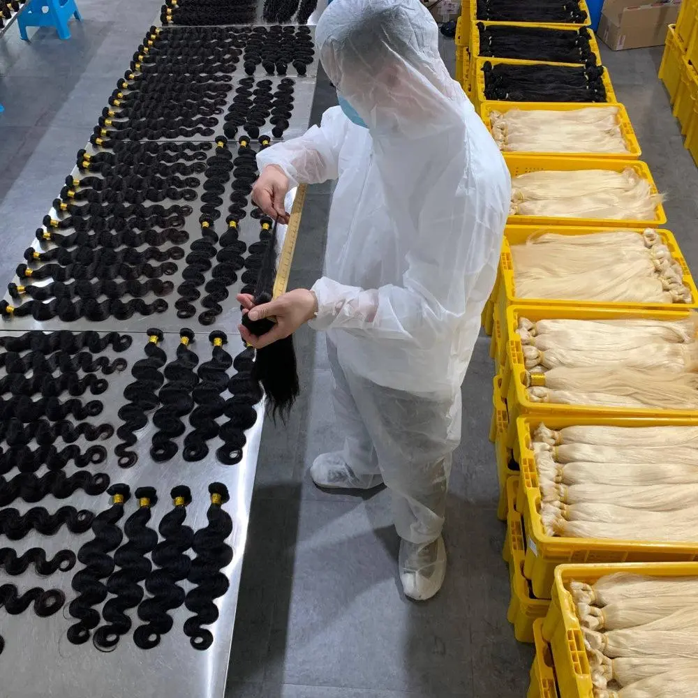 Human hair bundles manufacturer inspecting hair quality before wholesale shipment